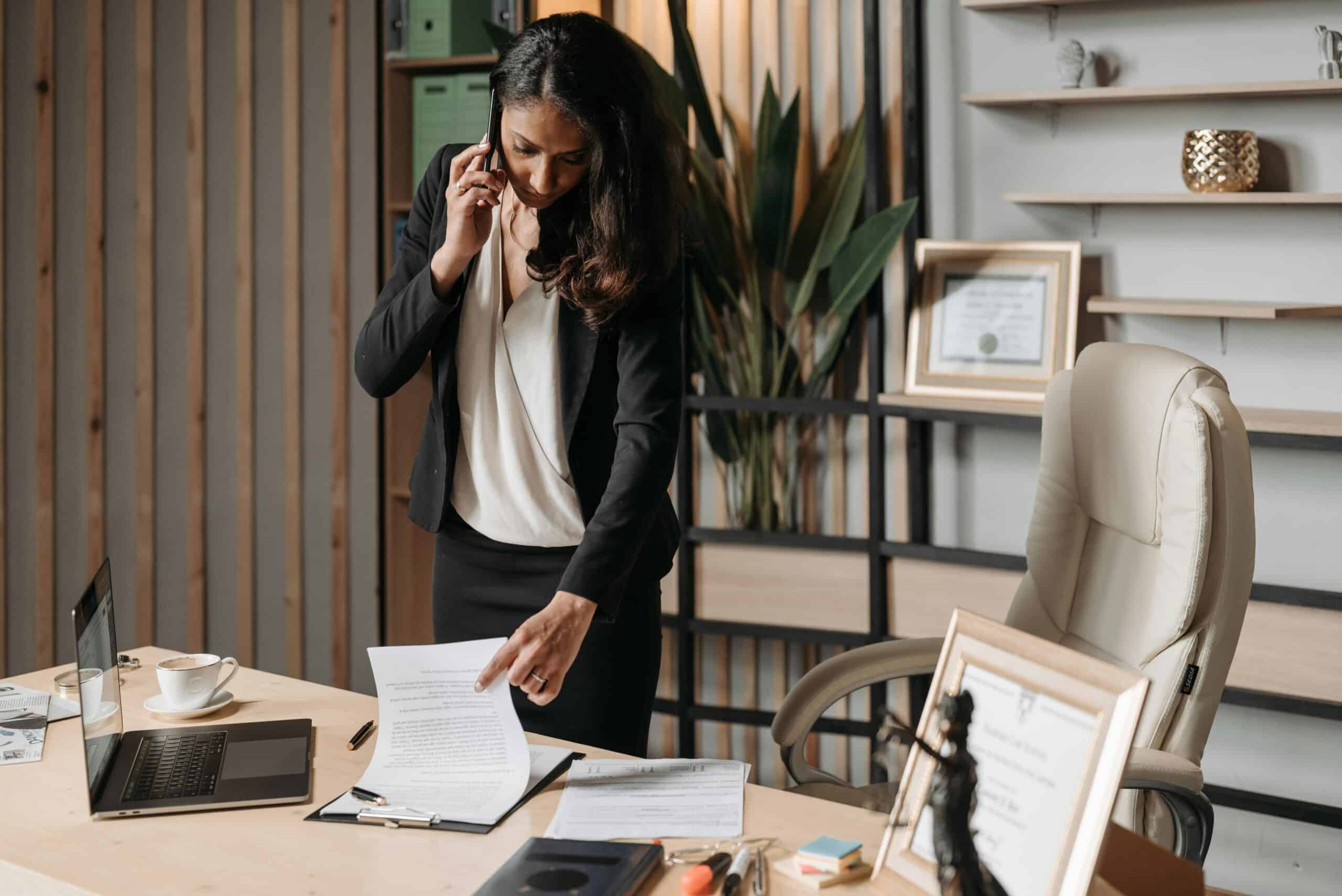 Woman looking through papers on a desk